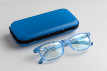 Transparent glasses with blue storage case on white background. Clean and modern product image for optical promotions or e-commerce listings.