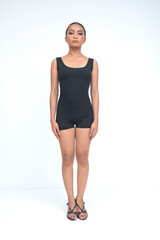 Fototapeta premium A confident young asian woman standing tall and looking directly at the camera with both hands resting naturally on her sides. Isolated on a white background.