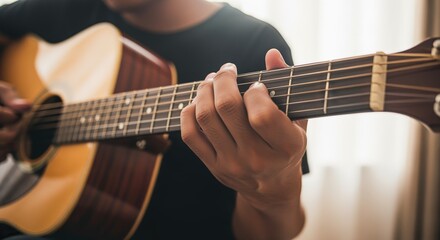 Fototapeta premium Man playing acoustic guitar close up, hand on fretboard, artistic expression, musical instrument, entertainment
