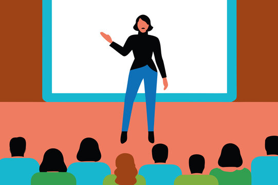 A woman delivers a presentation to a diverse audience in a conference hall. The atmosphere is professional as attendees listen attentively to the speaker’s insights