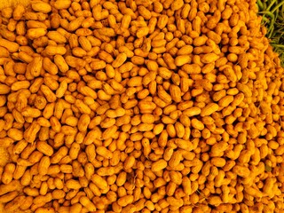 Golden roasted peanuts tightly packed together, showcasing their crunchy texture and rich flavor. A perfect visual for themes of healthy snacking, organic food, and traditional treats