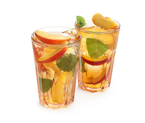 Refreshing iced peach tea in glasses isolated on white