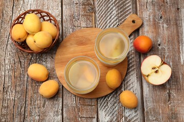 Tasty compot and fruits on wooden table, flat lay