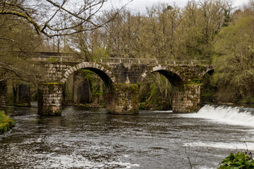 Original Roman bridge with several arches over the Arnoia River. Freixo Bridge. Ourense