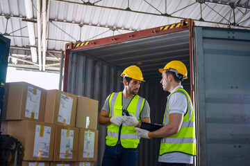 Blue collar workers are working at warehouse.