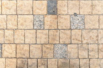 abstract background of an old beige and grey tiles on the track in the park top view