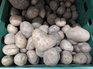 Potatoe in the form of heart in a box with potatoes