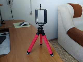 Red color tripod on the table