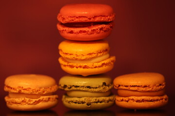 Colorful Macarons Stacked Against a Warm Background in Closeup View