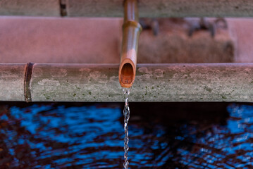 Water Flowing into a pool from Bamboo Pipe