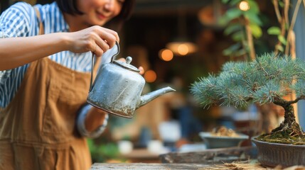 Woman watering a bonsai tree with a vintage watering pot.