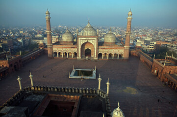 Aerial view of the grand Jama Masjid's red sandstone and white marble domes stand in stark contrast to the muted cityscape, Delhi, Delhi, India.