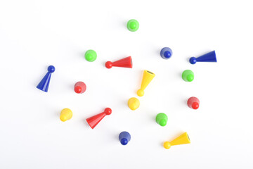 Colorful board game pieces isolated on white background, top view