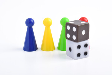 Colorful board game figures and dice isolated on white background