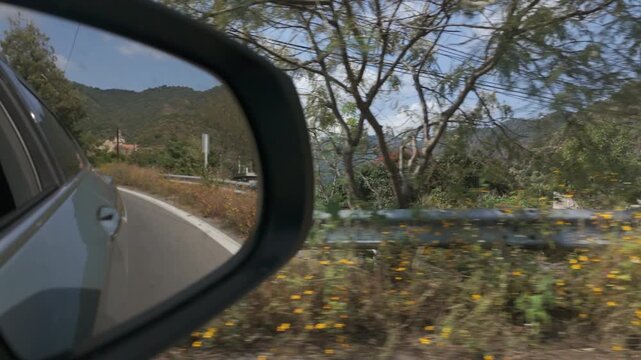 Malinalco, Mexico. View through side mirror driving through the countryside.