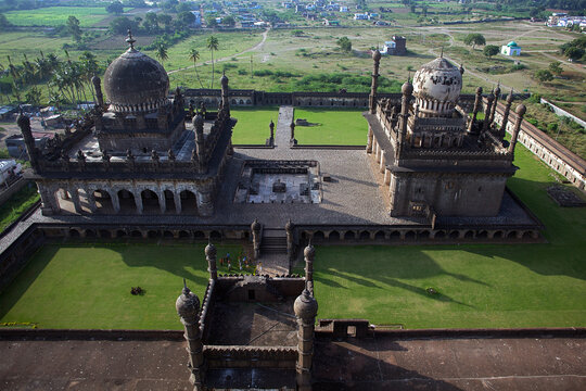 Aerial view of Ibrahim Rouza with the mosque and tomb standing majestically amidst the lush greenery, a serene blend of architecture and nature, Vijayapura, Karnataka, India.