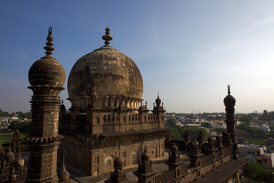 Aerial view of the majestic Ibrahim Rouza complex with its intricate details standing against the backdrop of the city under the expansive sky, Vijayapura, Karnataka, India.