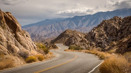 Scenic Mountain Road Trip: Winding Asphalt Through Rugged Terrain Under a Dramatic Sky