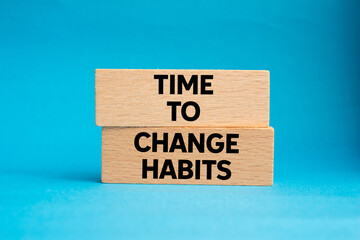 Time to change habits message written on wooden blocks on blue background. Conceptual time to change habits symbol. Copy space.