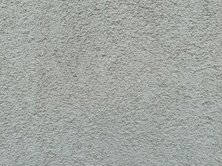 Horizontal light gray plaster wall with rough textured surface. Architectural background close-up, neutral construction material grungy old backdrop for design or copy space