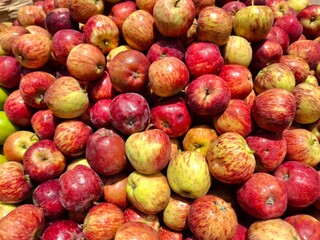 A vibrant pile of fresh red apples, tightly packed and gleaming with natural freshness&mdash;ideal for themes of organic produce, healthy eating, farm harvest, and natural food photography