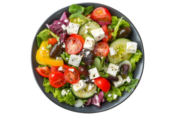 Fresh vegetable salad with feta cheese on plate isolated on transparent background. Healthy Greek salad with feta, cucumber, tomato, and lettuce PNG.
