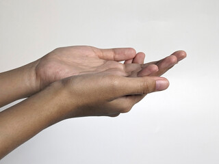 Close-up of two cupped hands held open and upward against a clean white background, showcasing palms and fingers in soft natural light.