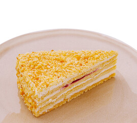 Delicious layered cake slice with cream and fruit filling on a plate