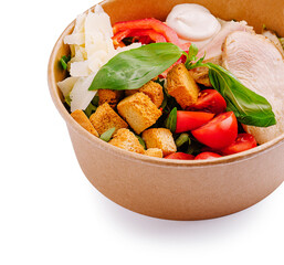 Fresh salad bowl with grilled chicken and croutons in a takeout container