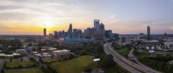 Charlotte, United States - 30 July 2025: Aerial view of the Charlotte skyline, showcasing Bank of America Stadium bathed in the soft glow of the setting sun.