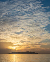 the sunset image of clouds covering the sky in stripes