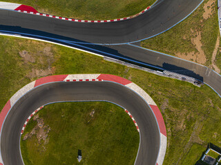Concord, United States - 28 July 2025: Aerial view of the Charlotte Motor Speedway's winding asphalt, a ribbon of grey cutting through the vibrant green fields.