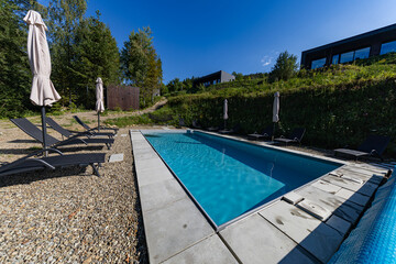 Modern cabins and swimming pool in the Carpathians on a sunny day