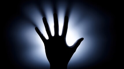 Silhouette of an open human hand with fingers extended upward against a radiant blue background,