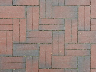 Red clinker bike path laid in a herringbone pattern. Close-up. Ideal as a background or texture. Copyspace