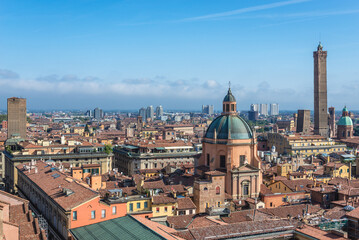 Fototapeta premium Panorama of historic part of Bologna city, Italy - view from St Petronius Basilica with dome of Santa Maria della Vita church and Two Towers
