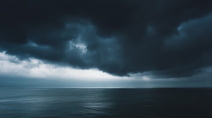 A dramatic seascape under dark, moody clouds, with a hint of light reflecting off the calm water, creating a serene yet ominous atmosphere.