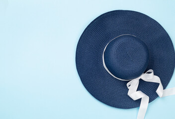 Blue beach hat on color background,top view