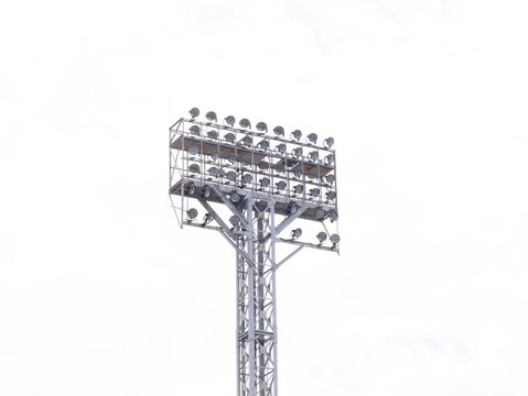 Floodlight tower against bright white sky