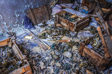 Old gas masks and filter canisters in 3rd High school in Pripyat abandoned city, Chernobyl Exclusion Zone, Ukraine
