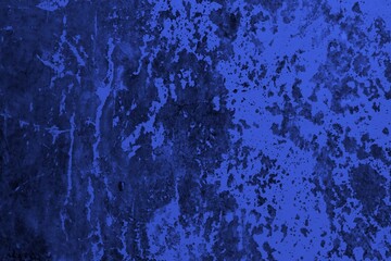 Close-up view of a blue textured wall showing rough patterns and intricate shadow details, offering a visually appealing background texture for versatile creative uses.