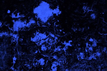 Close-up view of a blue textured wall showing rough patterns and intricate shadow details, offering a visually appealing background texture for versatile creative uses.