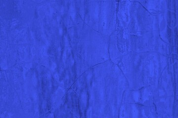 Close-up view of a blue textured wall showing rough patterns and intricate shadow details, offering a visually appealing background texture for versatile creative uses.