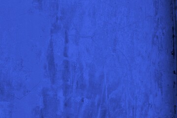 Close-up view of a blue textured wall showing rough patterns and intricate shadow details, offering a visually appealing background texture for versatile creative uses.
