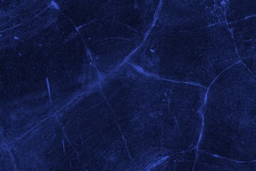 Close-up view of a blue textured wall showing rough patterns and intricate shadow details, offering a visually appealing background texture for versatile creative uses.