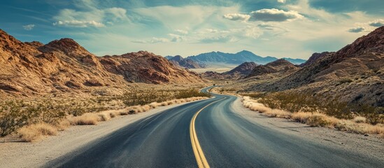 Winding road through desert mountains under a dramatic sky