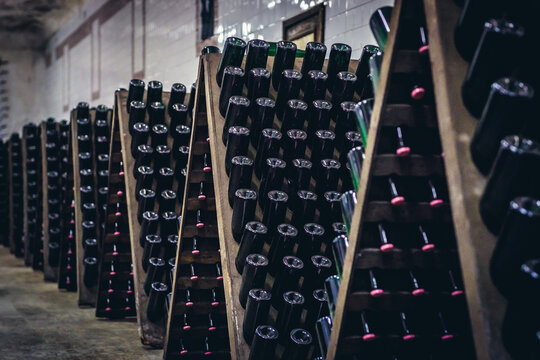 Bottles of sparkling wine during stage of production method called riddling in famous winery in Cricova town, Moldowa