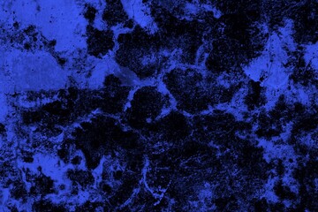Close-up view of a blue textured wall showing rough patterns and intricate shadow details, offering a visually appealing background texture for versatile creative uses.