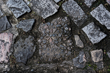 Stone floor, sidewalk of a street wet from the rain. Texture with water. Background for projects.