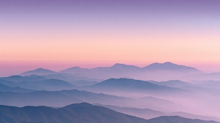 A breathtaking panoramic view of a majestic mountain range shrouded in a mystical layer of fog, bathed in the soft, warm glow of a sunrise or sunset, creating a serene and ethereal atmosphere.